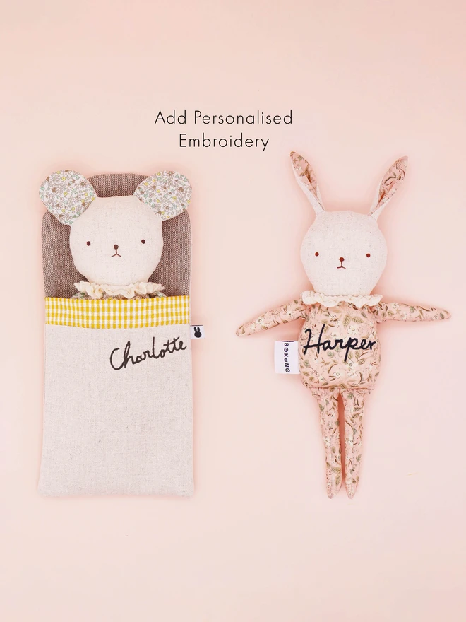 A handmade fabric doll in pastel floral prints, designed with distinct mouse and rabbit features. Each doll has a linen face, simple embroidered features, and delicate ruffled collars, showcasing their artisan craftsmanship.