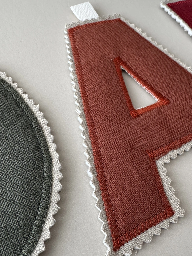 Linen Name Garland. Letter A in a rusty orange linen