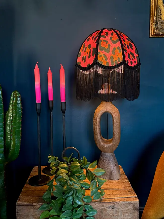 Vintage Fringed Dome Lampshade In Neon Leopard, in a room. 