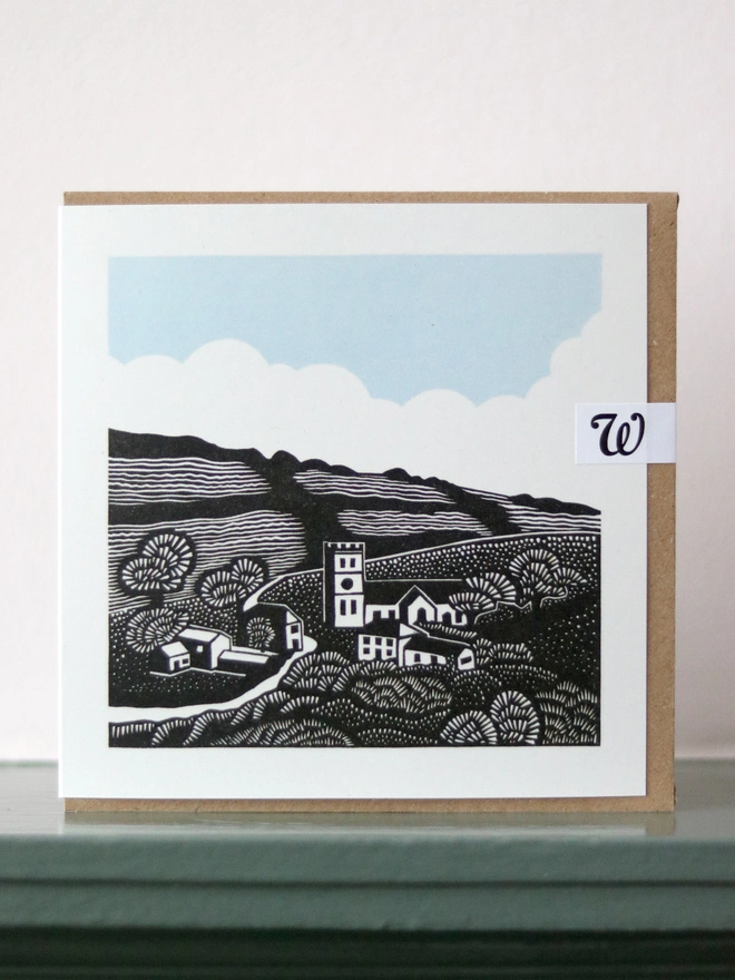 Greetings card featuring a linocut design of a Cornish village landscape premium card 100% recycled