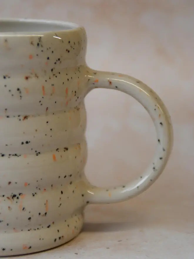 Speckle Pop’ handmade ceramic mug — close-up side view of speckled glaze and curved handle
