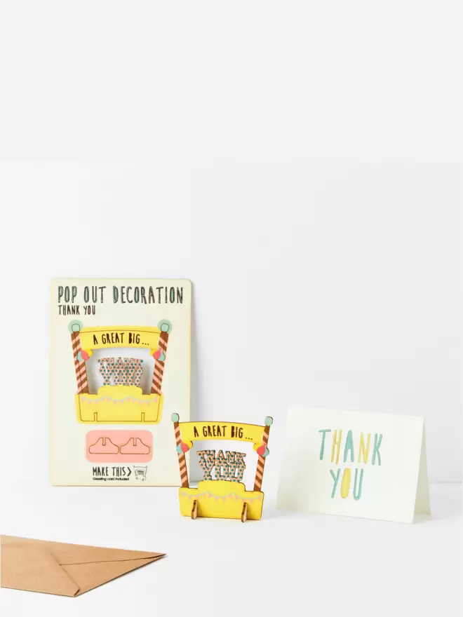 Thank you pop out decoration and thank you card and brown kraft envelope on a white background