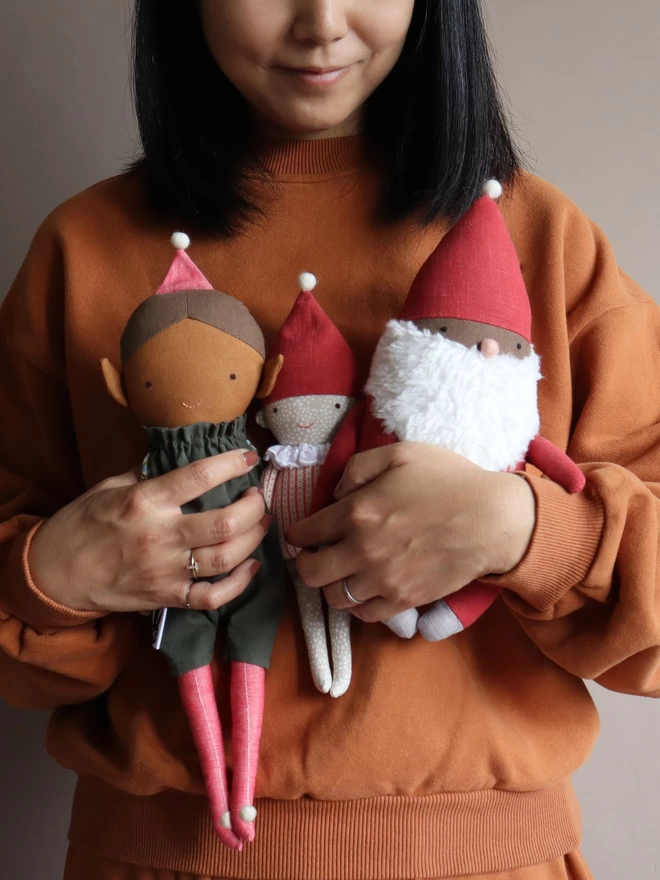 elf dolls and santa in christmas outfit 