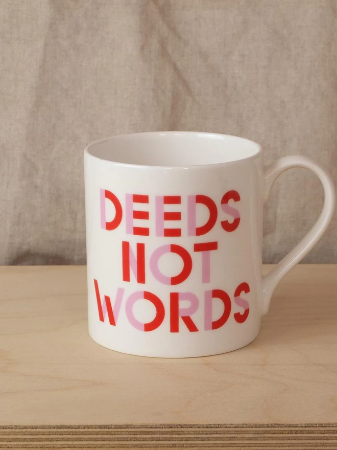 Black & Beech white mug with Deeds Not Words written on both sides in Pink and Red 