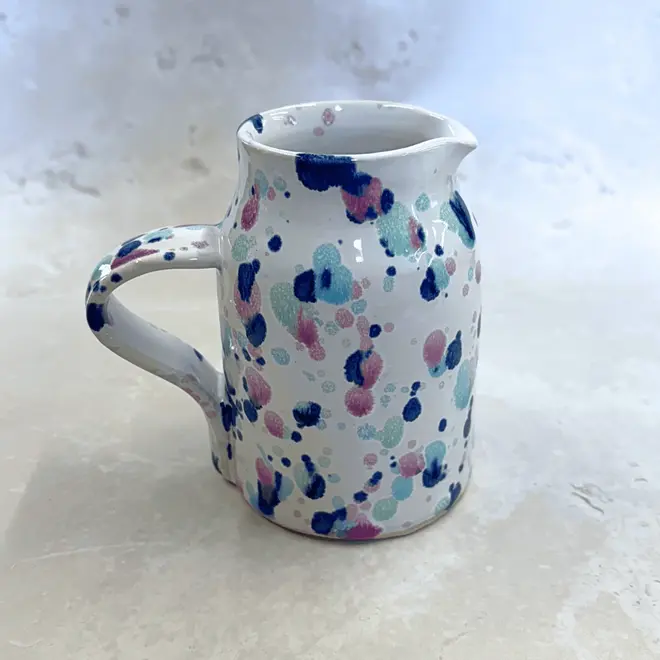 Sweetpea Small Jug, a colourful jug placed on a stone surface. 