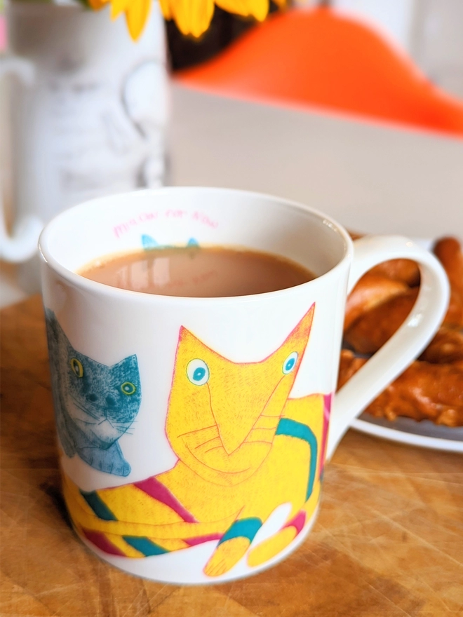 close up of charity miaow for now fine bone china cat gift mug featuring bright colour cats drawings