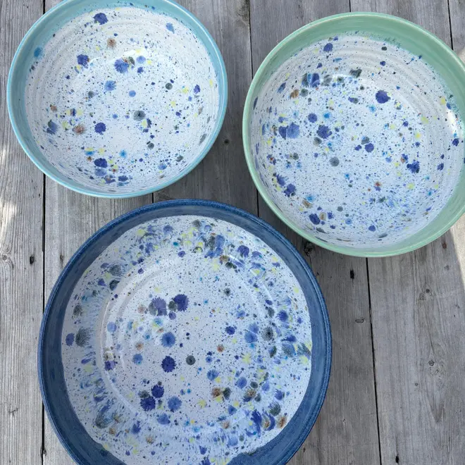 Shoreline Serving Bowls (Set Of 3), a collection of colourful serving bowls on a wooden surface. 