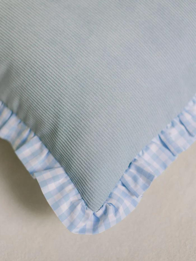 light blue corduroy and gingham dog bed corner