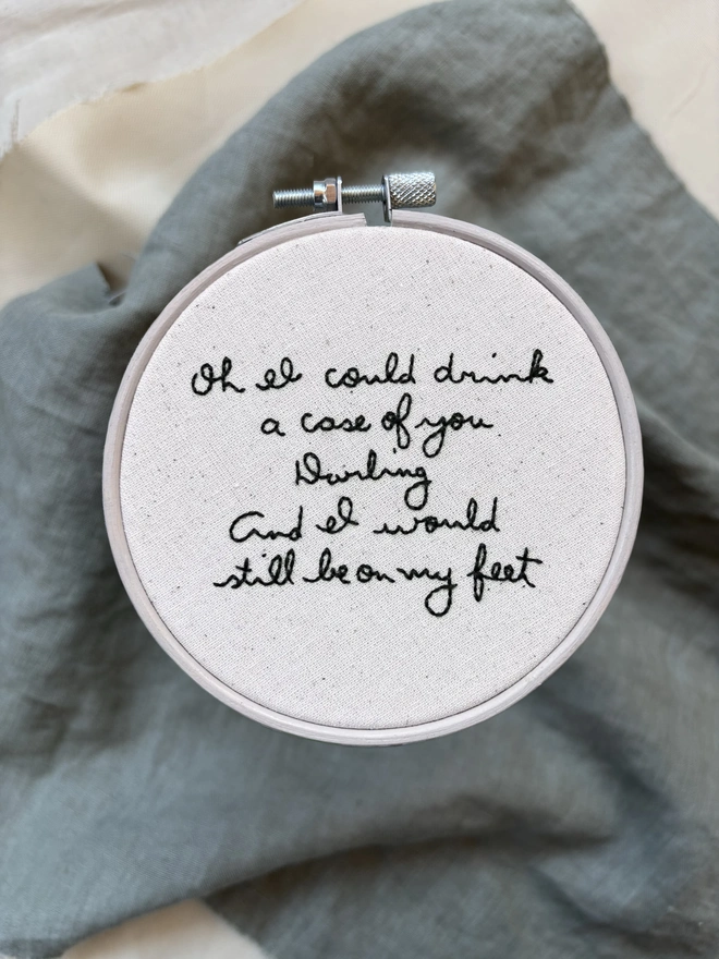 A case of you hand embroidered lettering on cotton calico in wooden hoop