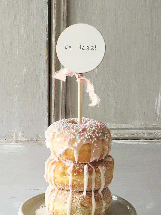 Wooden circle shaped cake topper with hand painted message and custom ribbon