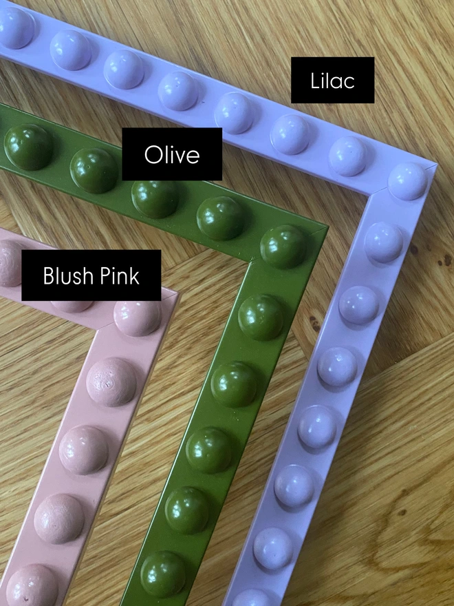 Colour swatches of bobbin mirrors in blush pink, olive green and lilac