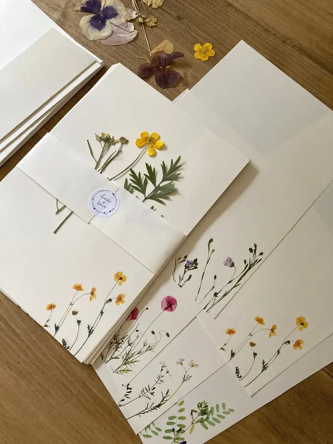 Pressed Wildflower Letter Writing Set, a pressed flower writing set sitting on a wooden surface. 