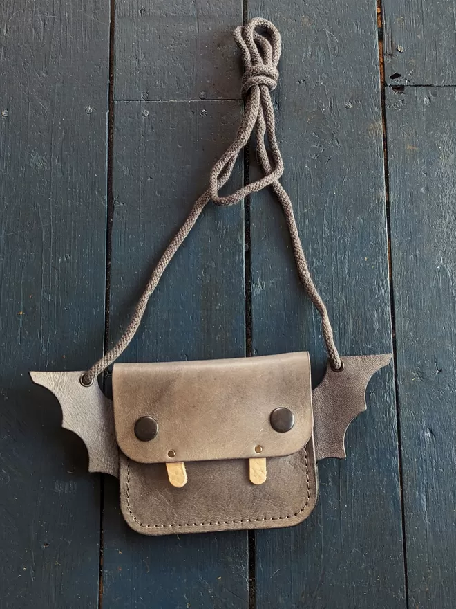 Front view of handmade leather Bat cross body purse.