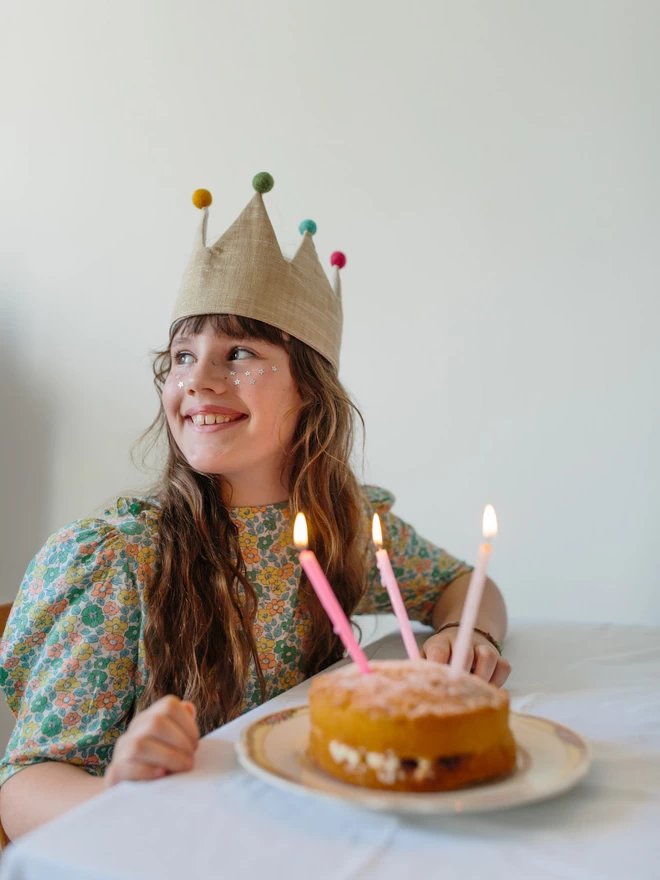 Girl with birthday cake and gold crown