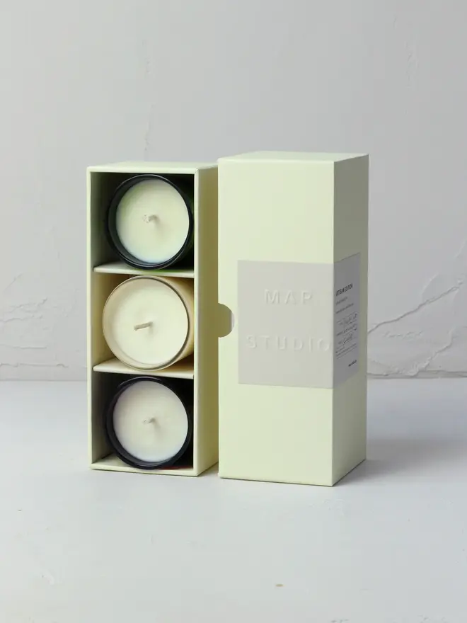 small aromatherapy soy candles (set of 3). candles shown inside packaging box.