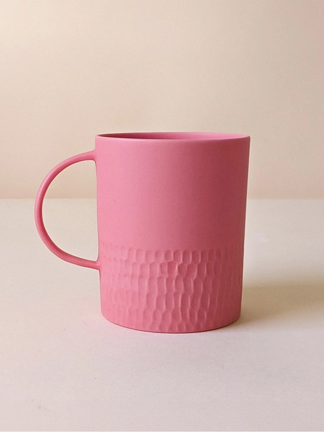 Large Morning Tea Mug made of porcelain in a Milkshake Pink with hand carved scalloped texture.