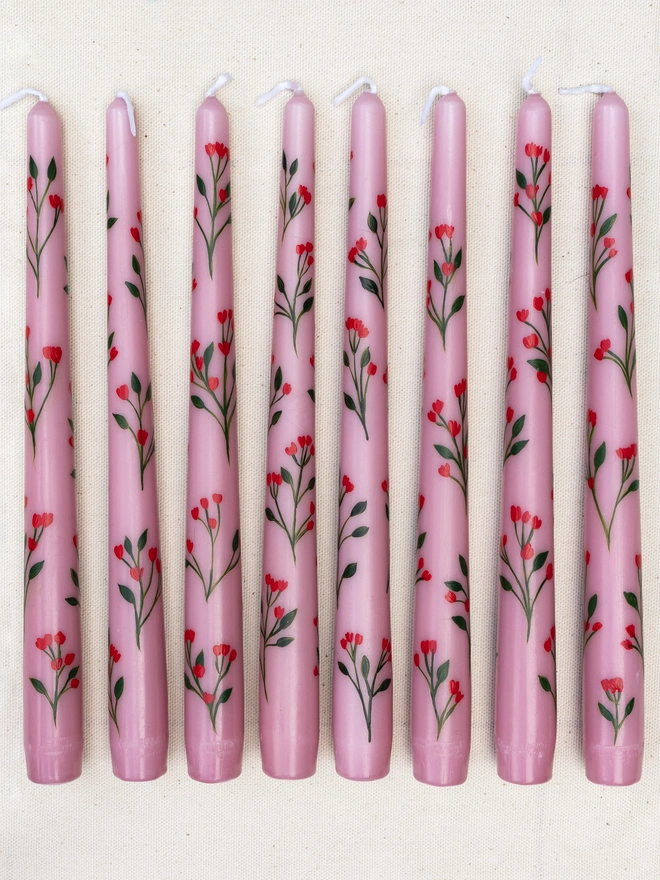 Pink taper candles hand painted with wildflower blossoms. 