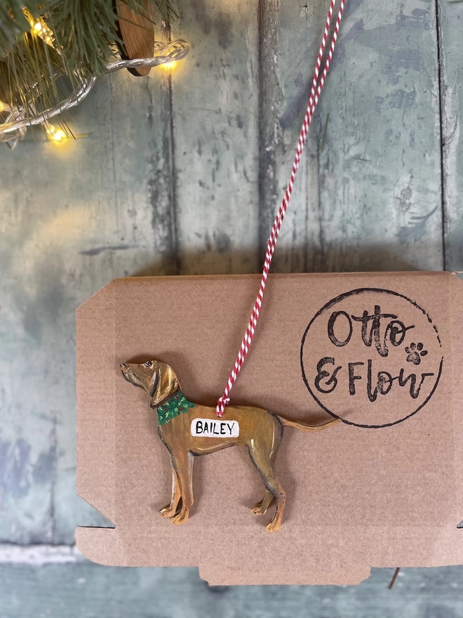 A Vizsla Christmas Decoration placed onto a box with Otto & Flow stamping 