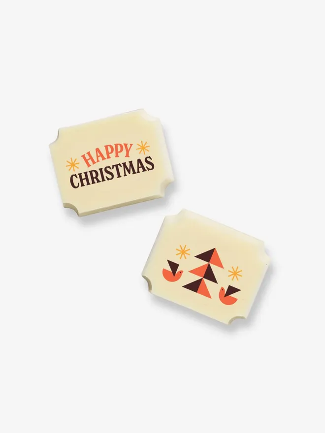 Two white chocolates with a 'Happy Christmas' message, and an image of a Christmas tree