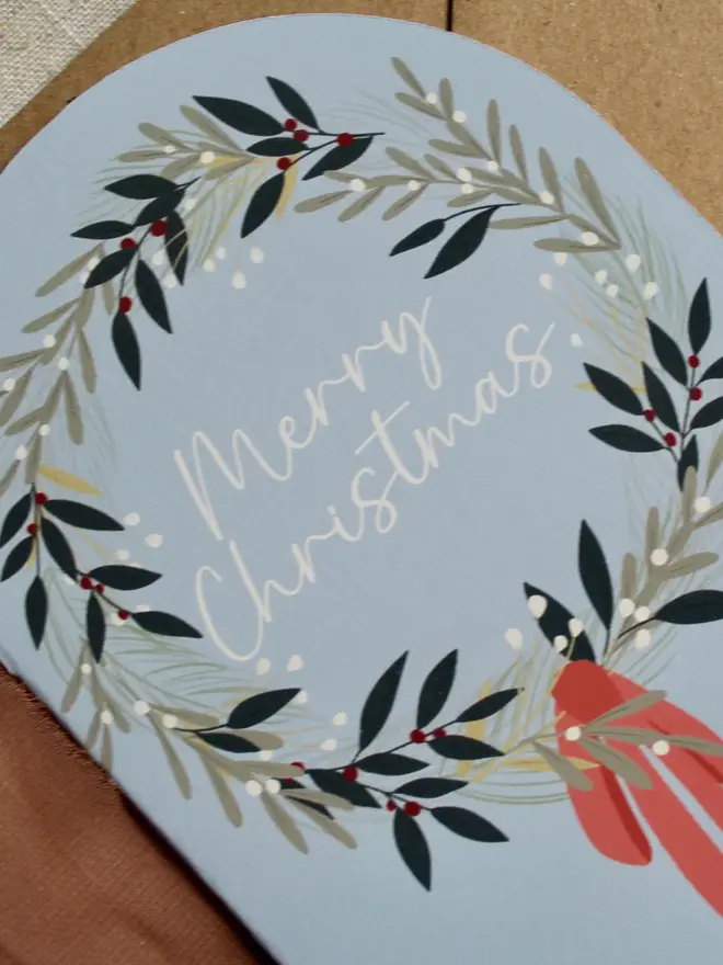 illustrated christmas wreath card. arch shaped christmas card illustrated with a wreath.