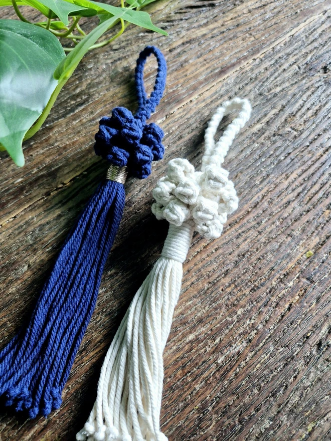 hanging door knob tassel in natural and navy, with a braided cord and decorative knots with a tasseled end, perfect for door, hallways, living room and dresser table knobs