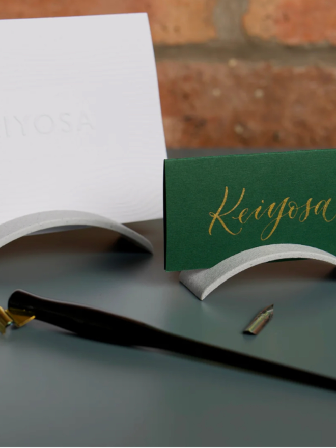 Hue Arch Place Card and Card Holder. The card is once again shown in the card holder, with a larger variant behind.