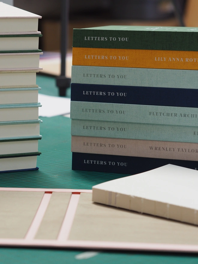 a stack of hardcover letters to your journals being made