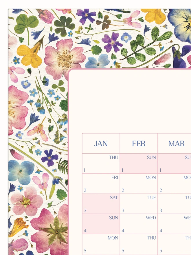 Close-up of a pretty floral year wall planner. A 2026 calendar with a delightful pressed flower design. Perfect for bringing a touch of the outdoors to any studio, home office or workspace. 