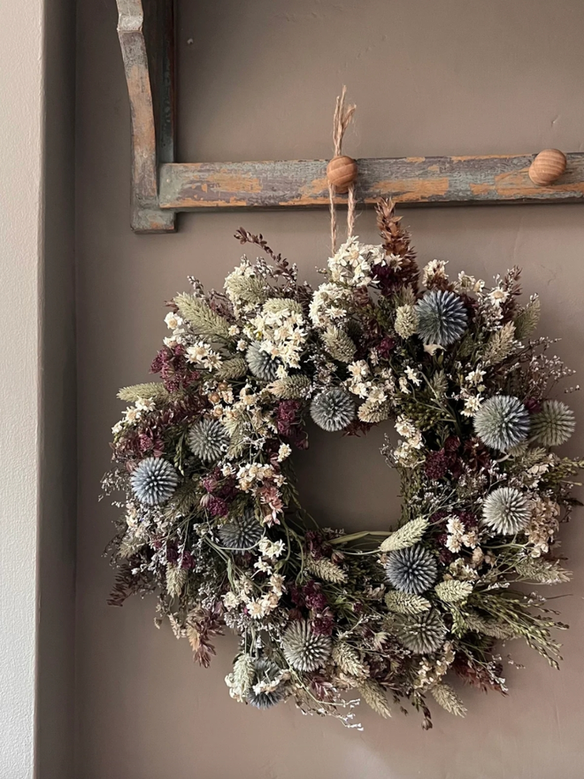 Winter Flowers Wreath. A wreath made of winter flowers and hung on a wall.