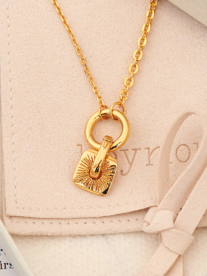 gold charm on necklace
