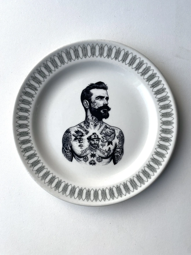 a vintage plate with ornate border, within the centre i have printed the vintage style image of a victorian tattooed sailor man
