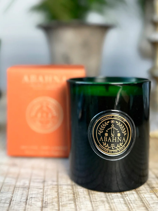 mandarin and sicilian bergamot natural wax candle. a green glass container candle and orange box.