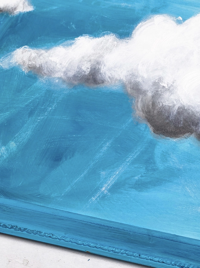large cloud painting in turquoise painted directly onto a frame