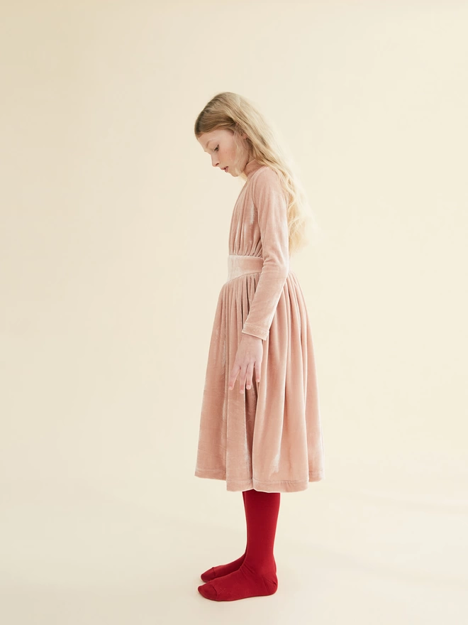 Dress made from a soft stretch velour. Midi-length with a slim bodice and turtle neck. Featuring a fully gathered shaped waistband. Concealed zip to centre back.