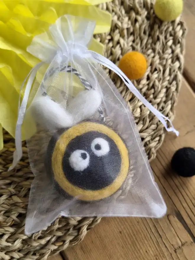 Felt bee decoration in an organza bag.