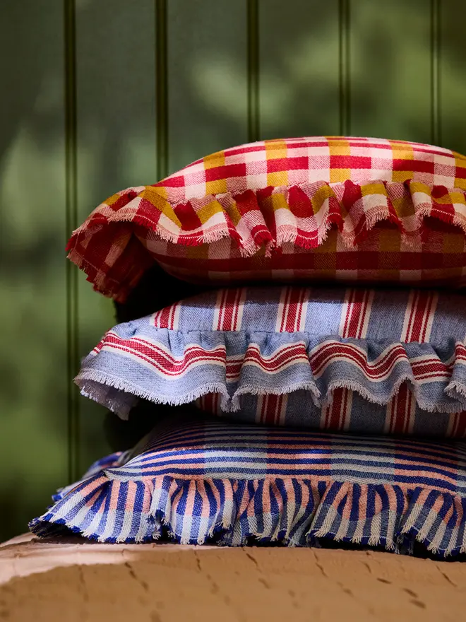 Rhubarb & Custard Cushion. Stack of cushions. Rhubarb & Custard is on top.