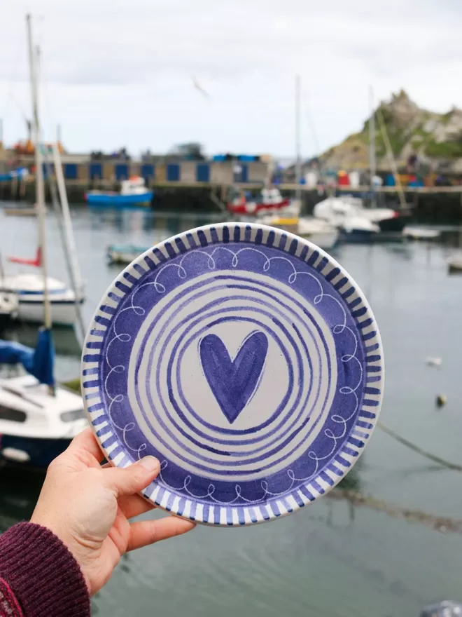 stripy heart plate in front of the harbour