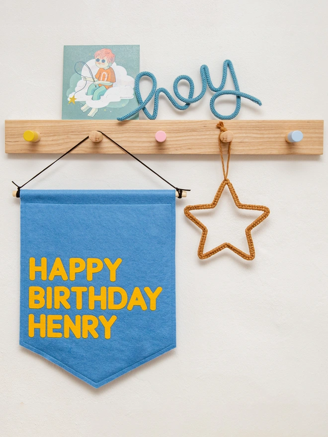 Happy birthday banner in cornflower blue and mustard.