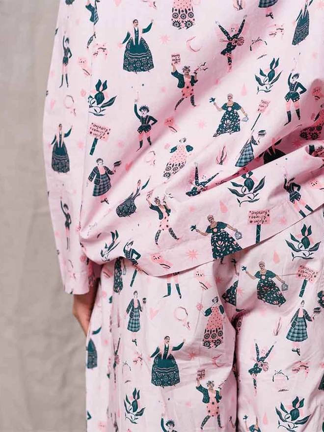 A back shot of our pale pink feminist pyjamas with our icon print