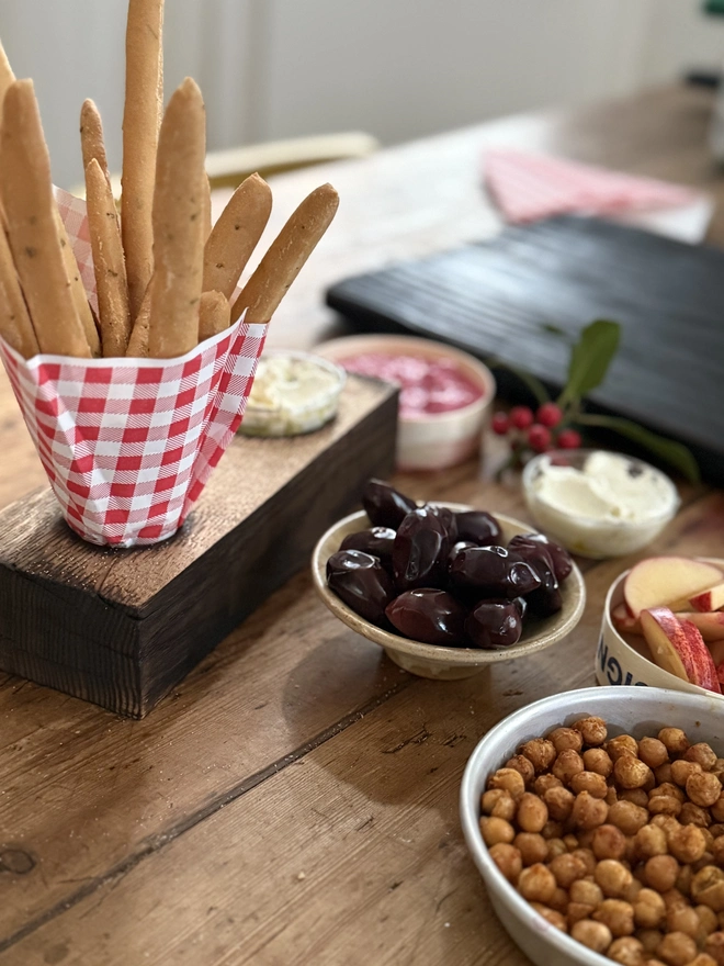 Chip and dip with bread sticks olives and nibbles 
