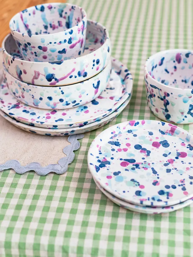 Sweetpea Pasta Bowl, a colourful bowl table surface. It is accompanied by more colourful kitchen items. 