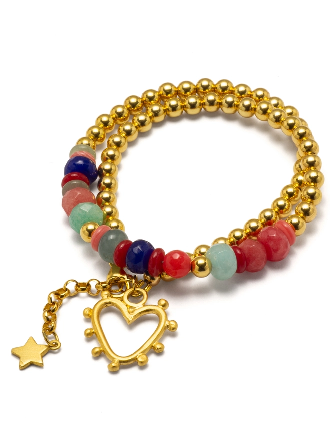 The Love Drunk Wrap Bracelet is a playful mix of colour and shine. This double-wrap design combines sleek metal beads with a pop of vibrant jade, finished with a mini studded heart and delicate star charm. Easy to wear and full of personality, it’s a joyful everyday piece made for stacking, gifting, or wearing solo when you need a little extra sparkle.