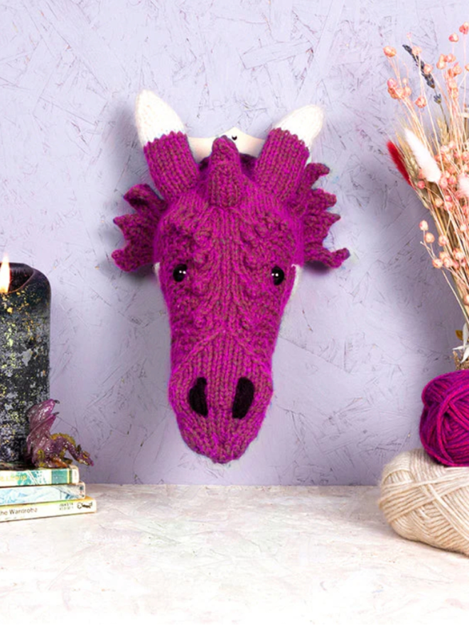 Dragon Head Knit Kit. A mini magenta dragon head.