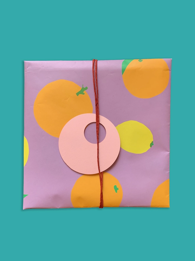 Oranges and Lemon gift wrapping paper tied with twine and gift tag
