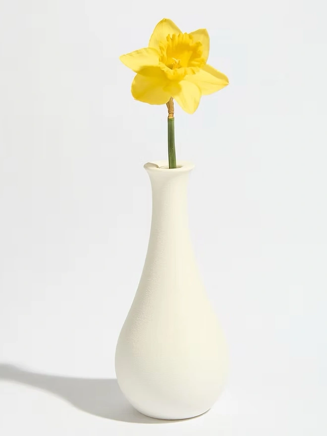 tear drop shaped white 3d printed vase with yellow flower