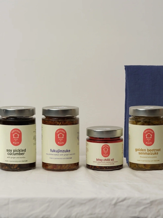 Omiyage Collection, a collection of oils and foods on a white surface. 