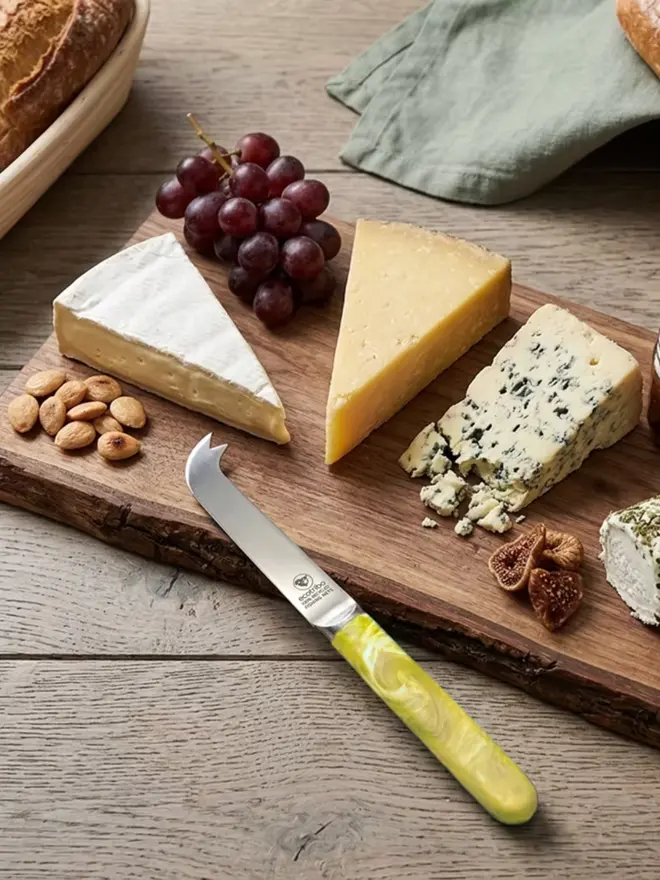 Handmade recycled plastic cheese knife with a unique ocean-inspired finish, made in the UK from ghost fishing nets.