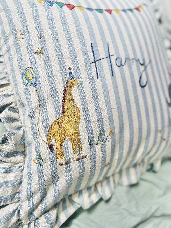 Hand Painted Giragge and ELephant celebrating the joy of the circus. Blue striped ruffle cushion with hand embroidered personalised name in the centre
