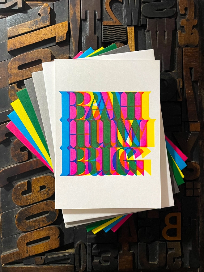 Bah Humbug! A beautiful typographic letterpress Christmas card set. Printed with rich vibrant and fluorescent blue, magenta and yellow inks with luxury matching and contrasting envelopes; ideal to send to your designer friends.