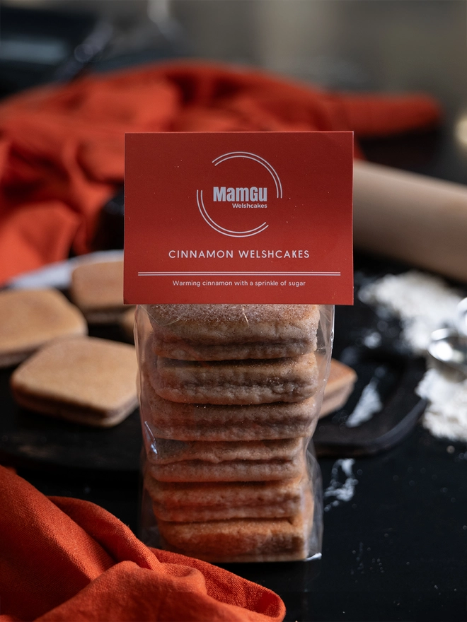 Packaged Cinnamon Welsh Cakes on a busy kitchen worktop